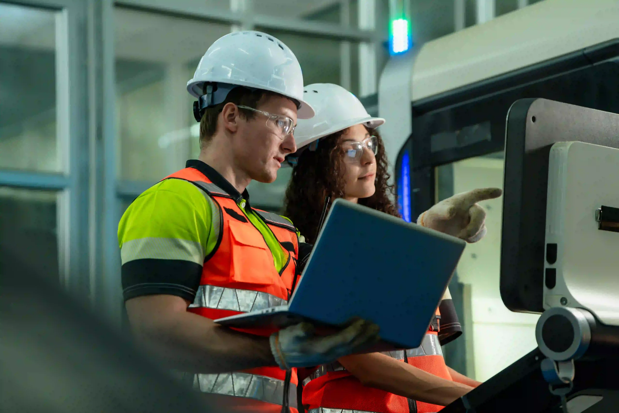 Two engineers in the lab look at a computer screen.