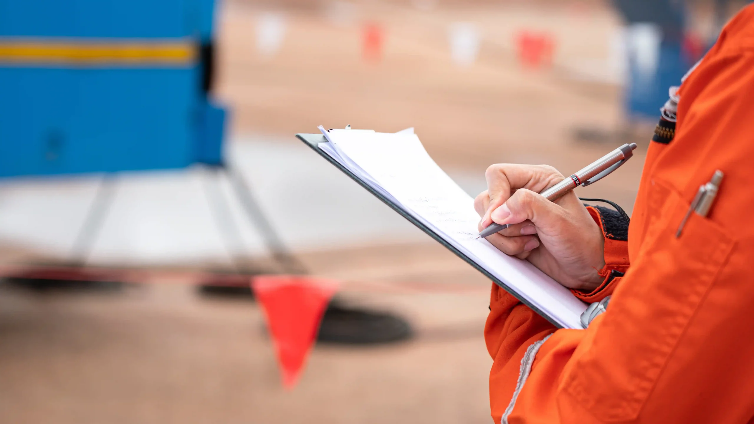 Auditor uses clipboard to complete on-site checklist.